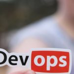 Marketing Automation - A close-up image featuring a DevOps sticker held by a person outdoors.