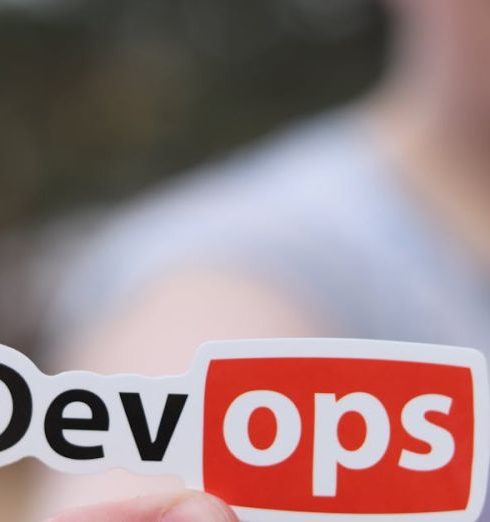 Marketing Automation - A close-up image featuring a DevOps sticker held by a person outdoors.