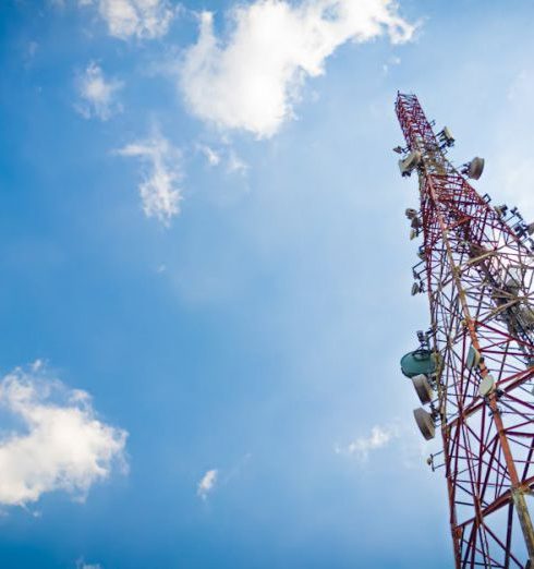 Marketing Channels - View of a tall telecom tower set against a clear blue sky in Depok, Indonesia.