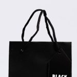 Brand Awareness - Minimalist black shopping bag with Black Friday tag, perfect for holiday sales themes.