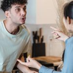 Conflict Resolution - A couple engages in a heated discussion in a contemporary kitchen, highlighting relationship dynamics.