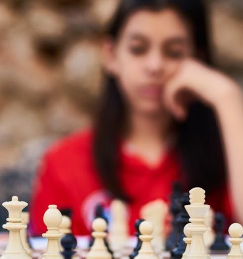 Decision Making - Child deeply focused on a strategic chess game outdoors in Turkey.