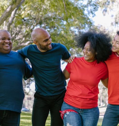 Diverse Teams - Six friends enjoy bonding outdoors, showcasing diversity and happiness.