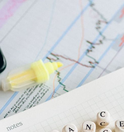 Change Management - Close-up of financial tools and letter blocks spelling 'CHANGE'.