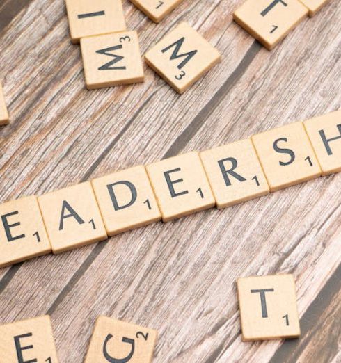 Leading By Example - Wooden letter tiles spelling 'LEADERSHIP' on a wooden surface, symbolizing leadership qualities and skills.