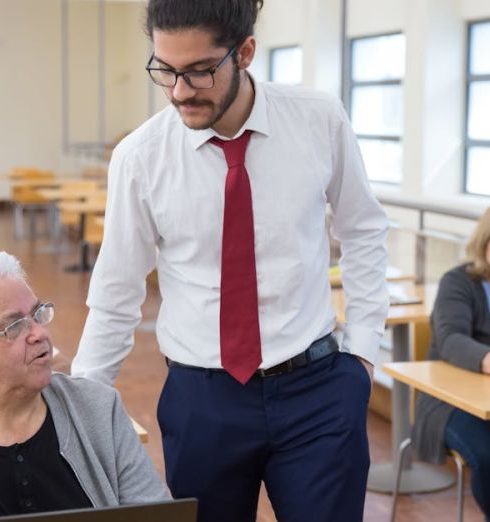 Continuous Learning - Group of seniors learning computer skills in a Portugal classroom setting.