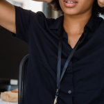 Conflict Management - Young businesswoman looking stressed at her desk in a modern office.