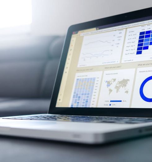 Data - Sleek laptop showcasing data analytics and graphs on the screen in a bright room.