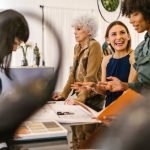 Product Demand - A group of diverse businesswomen having an interactive meeting in a modern office setting.