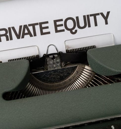 Acquisitions - Close-up of vintage typewriter with 'PRIVATE EQUITY' on paper, business concept.