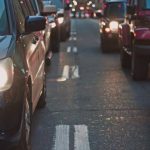 Traffic - A congested city street lined with cars stuck in traffic at dusk, showcasing urban life.