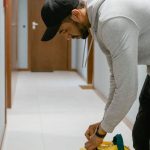 Subscription Services - A deliveryman in a hallway securing a food thermal bag.