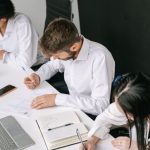 Agile Strategy - Diverse team working together in a sleek office with laptops and notebooks.