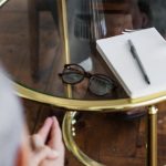 Service Strategy - Two adults discussing mental health in a counseling session across a glass table indoors.