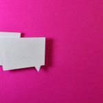 Live Chat - White speech bubbles on a vibrant pink background for communication or design concepts.