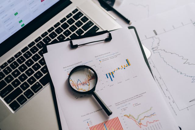 magnifying-glass-on-white-paper-with-statistical-data