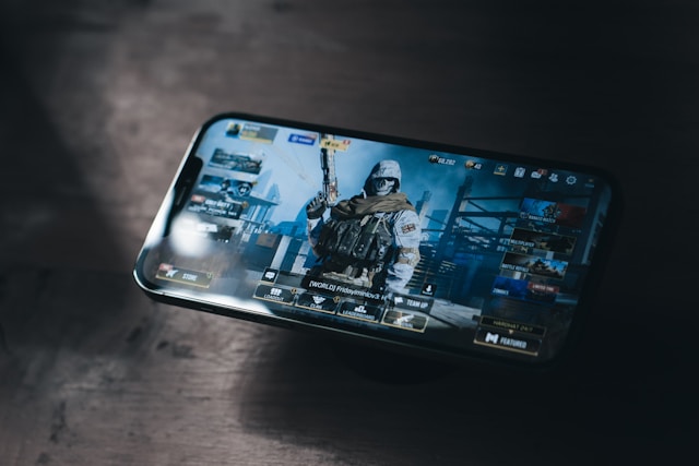 a-person-holding-a-cell-phone-with-a-video-game-on-the-screen